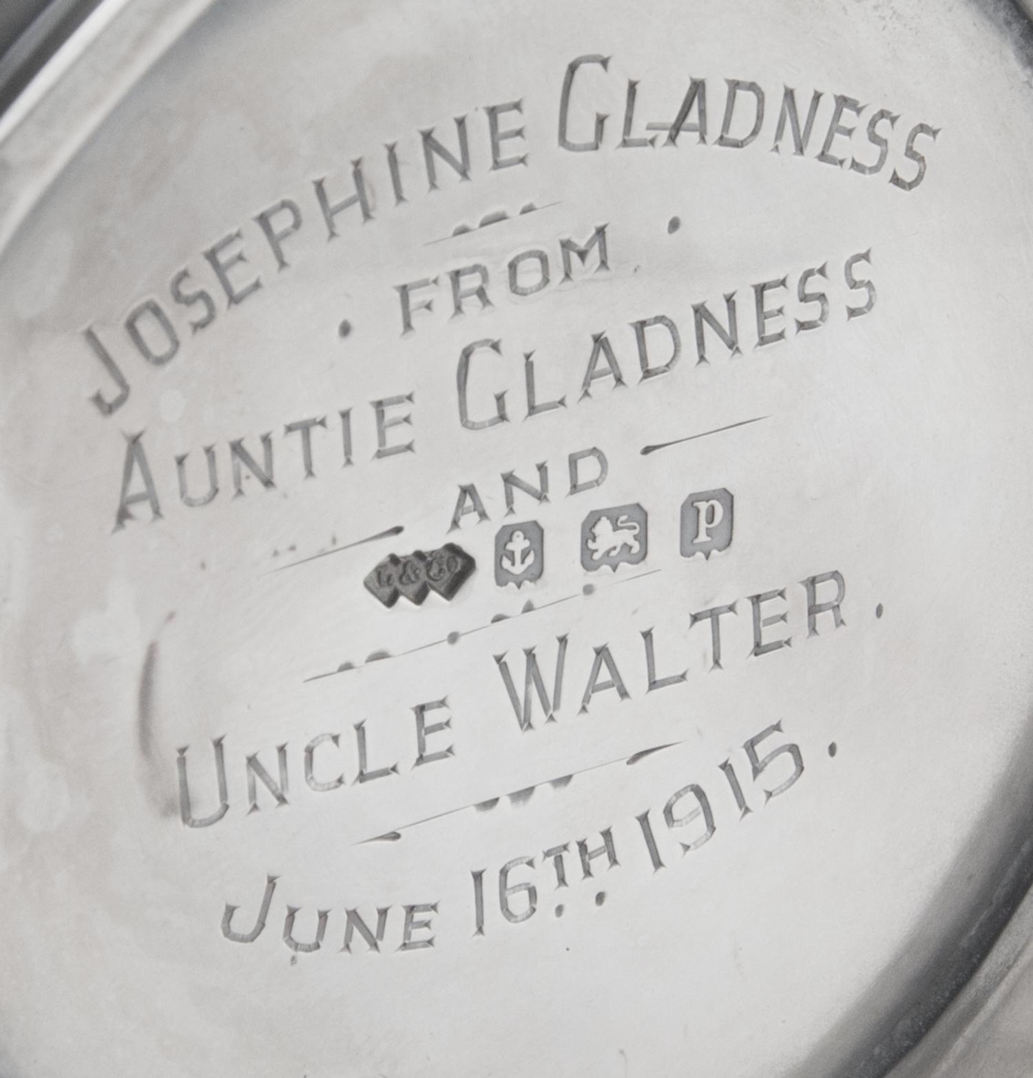 A George V Silver Mug, Liberty & Co., Birmingham, 1914, in the Arts & Crafts taste, with spot-hammered surfaces and stylized chased che