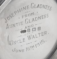 A George V Silver Mug, Liberty & Co., Birmingham, 1914, in the Arts & Crafts taste, with spot-hammered surfaces and stylized chased che