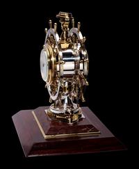 An English Steel and Brass Ship's Wheel Clock and Barometer, E&E Emanuel