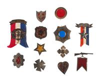 A group of 12 reproduction/fantasy corps badges collected for educational purposes, including: