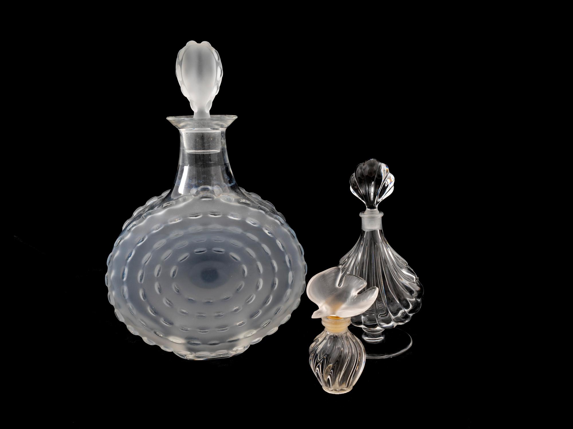 A Lalique Molded and Frosted Glass Decanter and Two Perfume Bottles — 20TH CENTURY