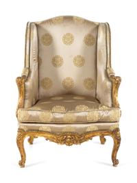 A Louis XV Style Carved Giltwood Bergère à Oreilles