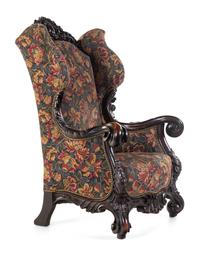 A Karpen Carved Mahogany Wingback Armchair