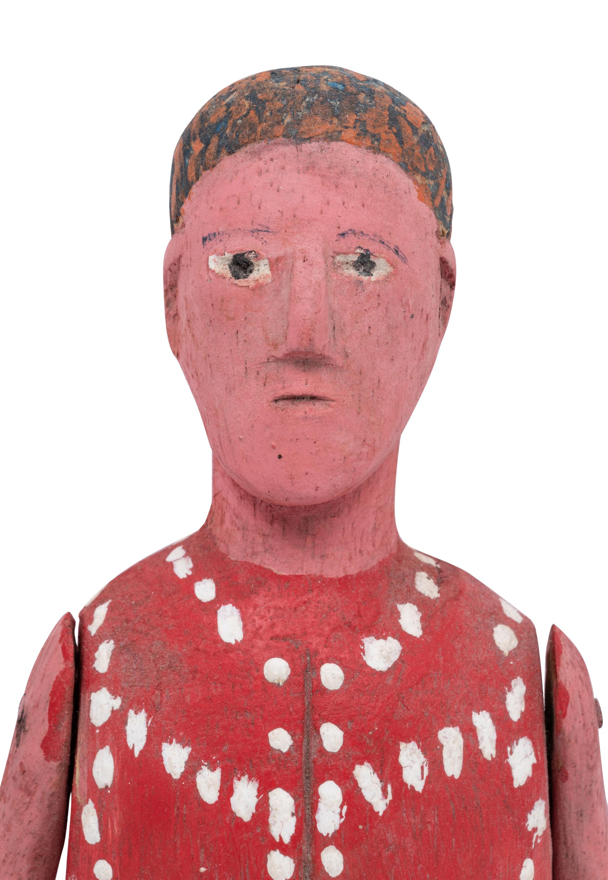 A Red Painted Wooden Figure