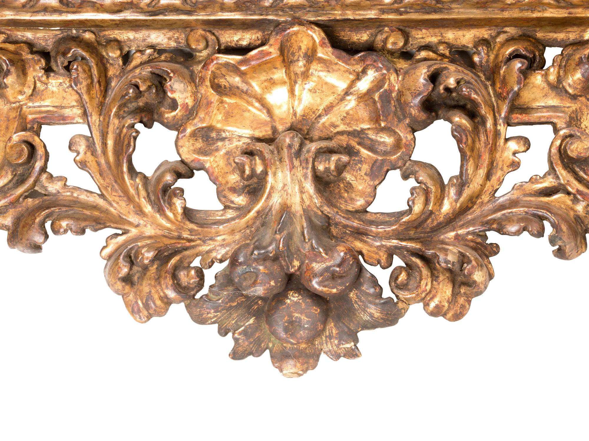 A Florentine Rococo Revival Carved Giltwood Overmantel Mirror