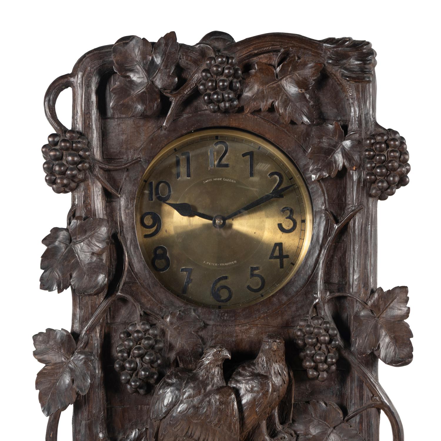 A Swiss Black Forest Carved Tall Case Clock