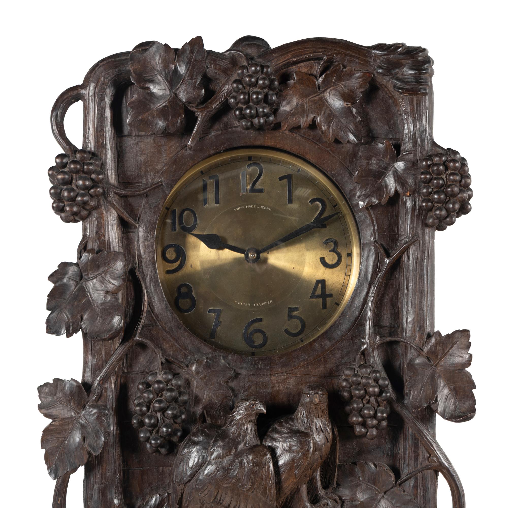 A Swiss Black Forest Carved Tall Case Clock