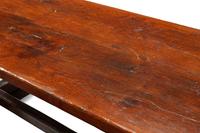 An English Baroque Style Walnut Trestle Table and a Pair of Associated Benches