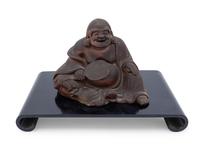 A Chinese Pottery Figure of a Laughing Buddha