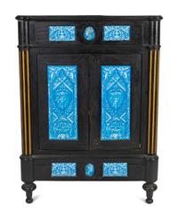 A Continental Blue Faience-Mounted Ebonized Cabinet