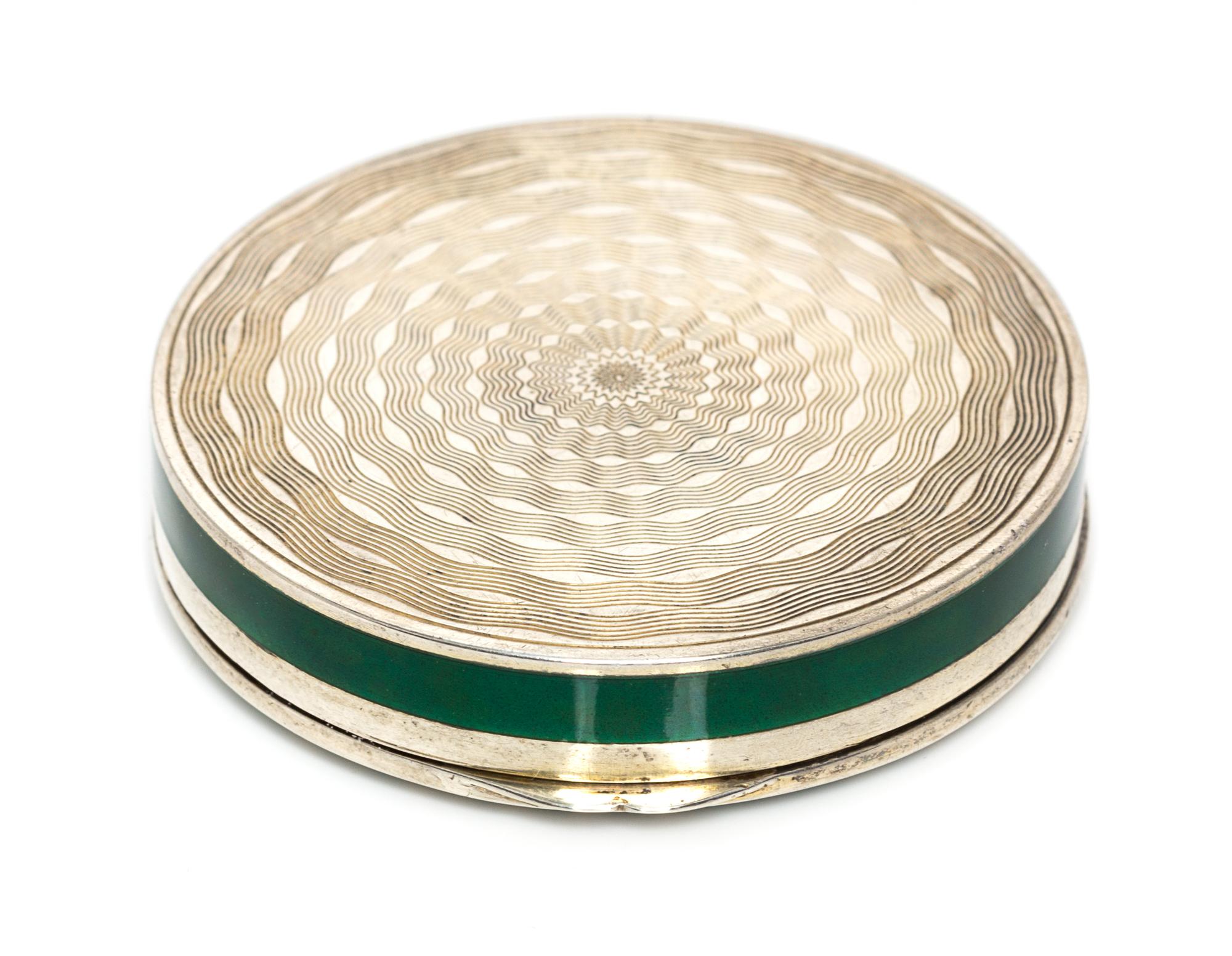 A Continental Silver and Enamel Compact, Import Mark C&C, London, 1925, of circular form, the lid with gilt and red foliate elements on