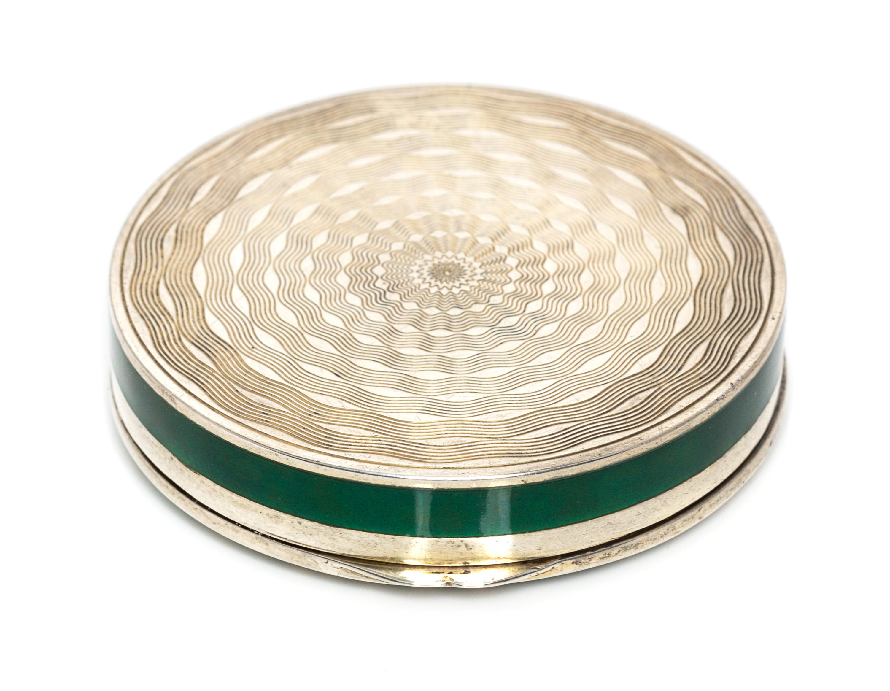 A Continental Silver and Enamel Compact, Import Mark C&C, London, 1925, of circular form, the lid with gilt and red foliate elements on