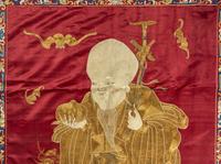 A Large Chinese Red Ground Embroidered Silk 'Longevity' Panel