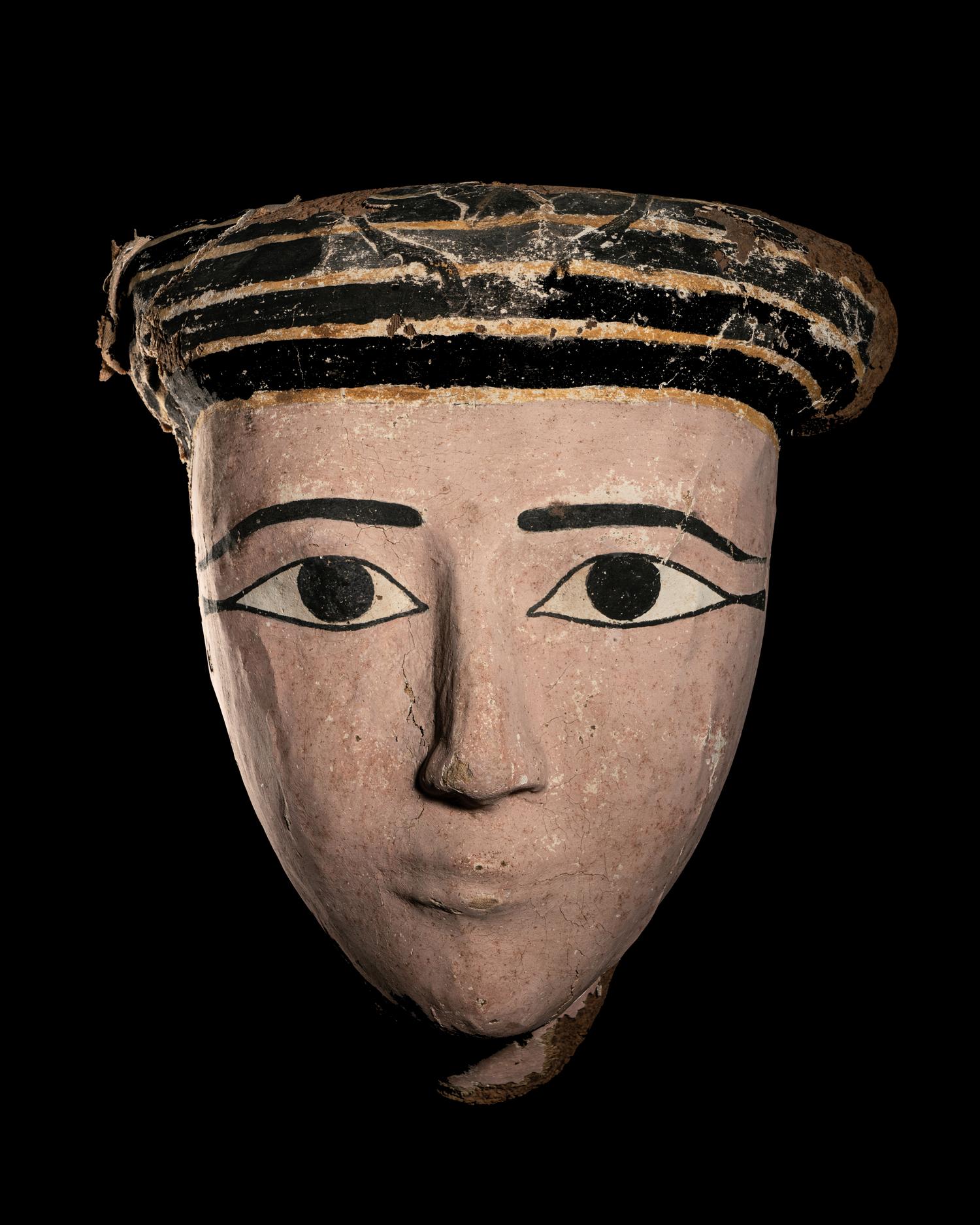 An Egyptian Wood and Painted Cartonnage Mummy Mask