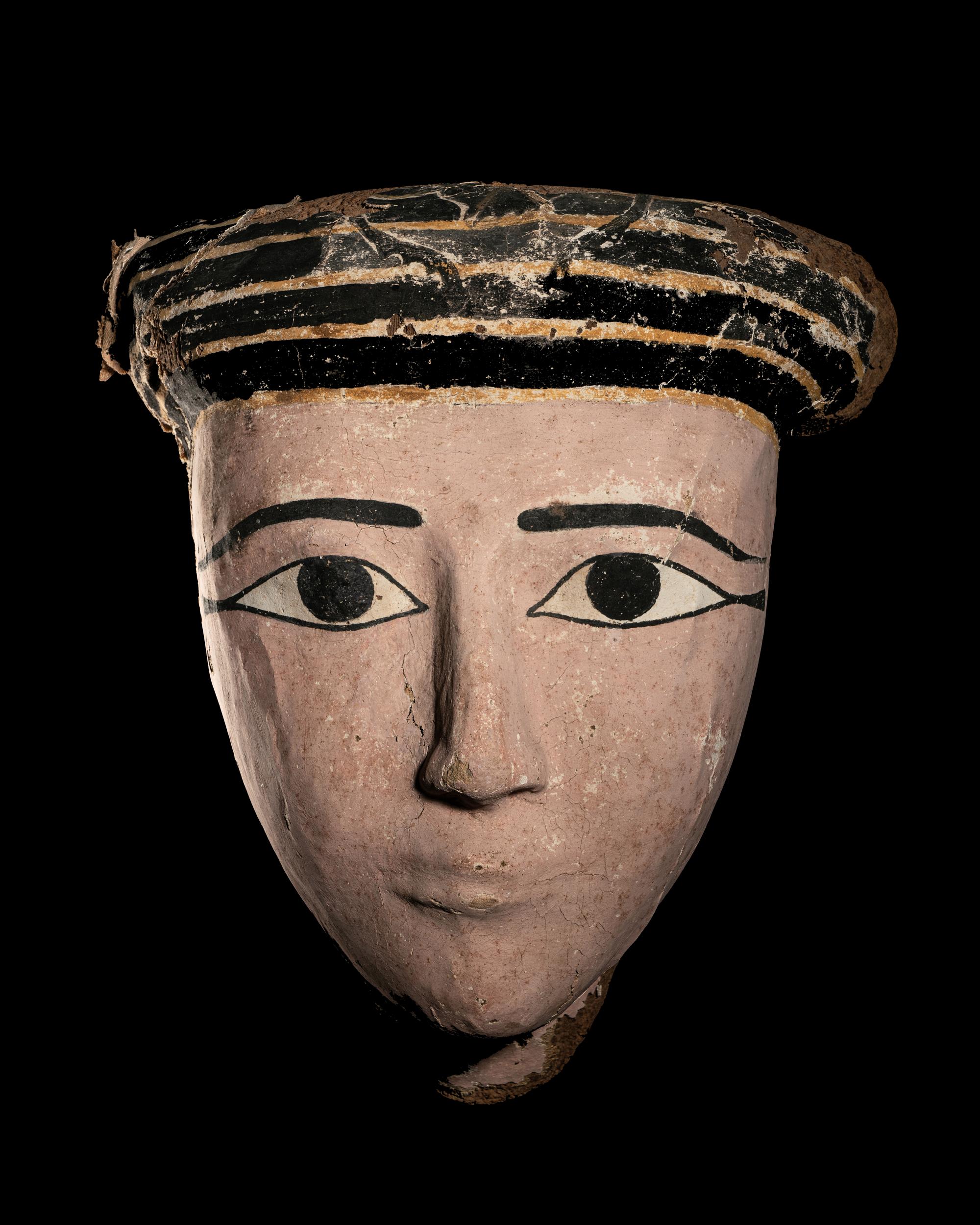 An Egyptian Wood and Painted Cartonnage Mummy Mask