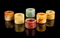 Six Chinese Hardstone Archer's Rings Diameter of largest 1 3/8 inches.