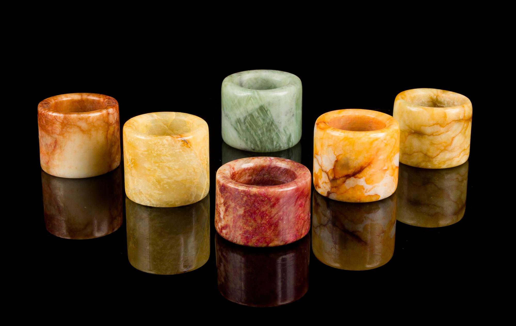 Six Chinese Hardstone Archer's Rings Diameter of largest 1 3/8 inches.