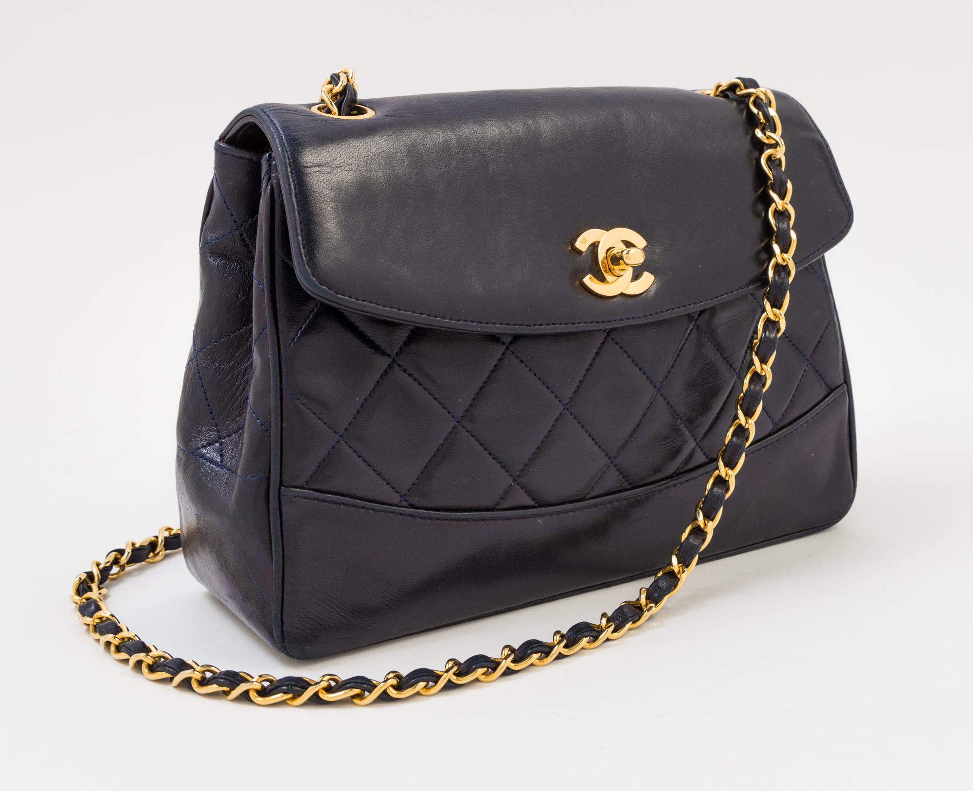 A Chanel Navy Lambskin Flap Shoulder Bag, 9.5" x 6.5" x 3"; Strap drop: 21".