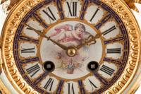A French Gilt Bronze and Sèvres Style Porcelain Clock Garniture