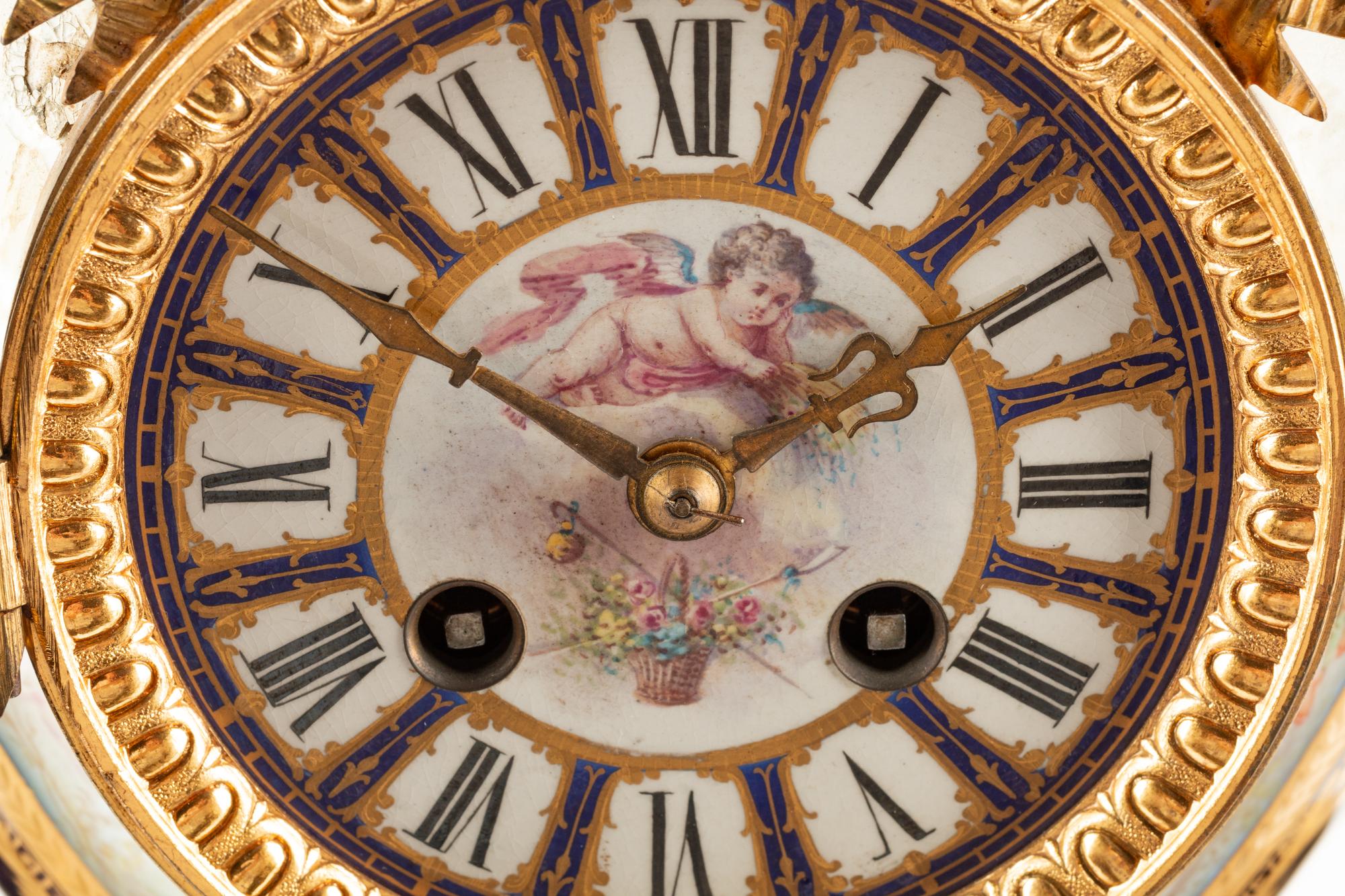 A French Gilt Bronze and Sèvres Style Porcelain Clock Garniture