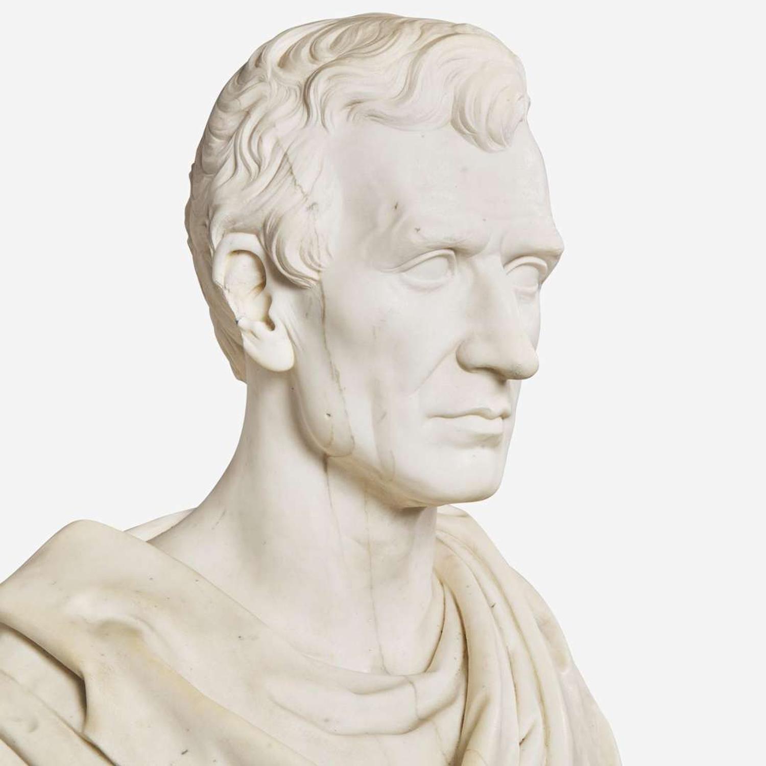 A carved Carrara marble bust of a Classically draped gentleman 19th century