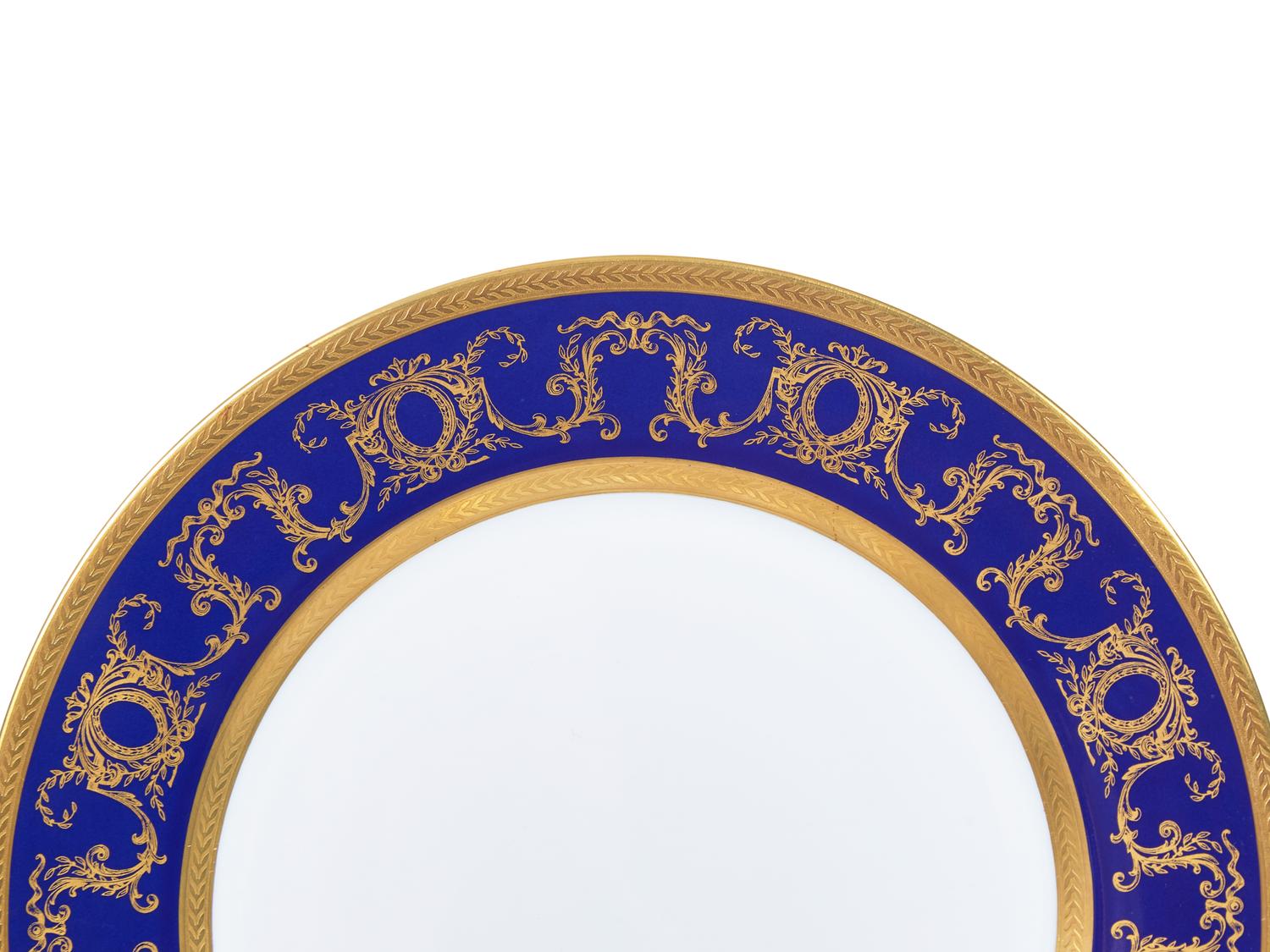 A Tharaud- Limoges Parcel Gilt and Cobalt Decorated Porcelain Dinner Service