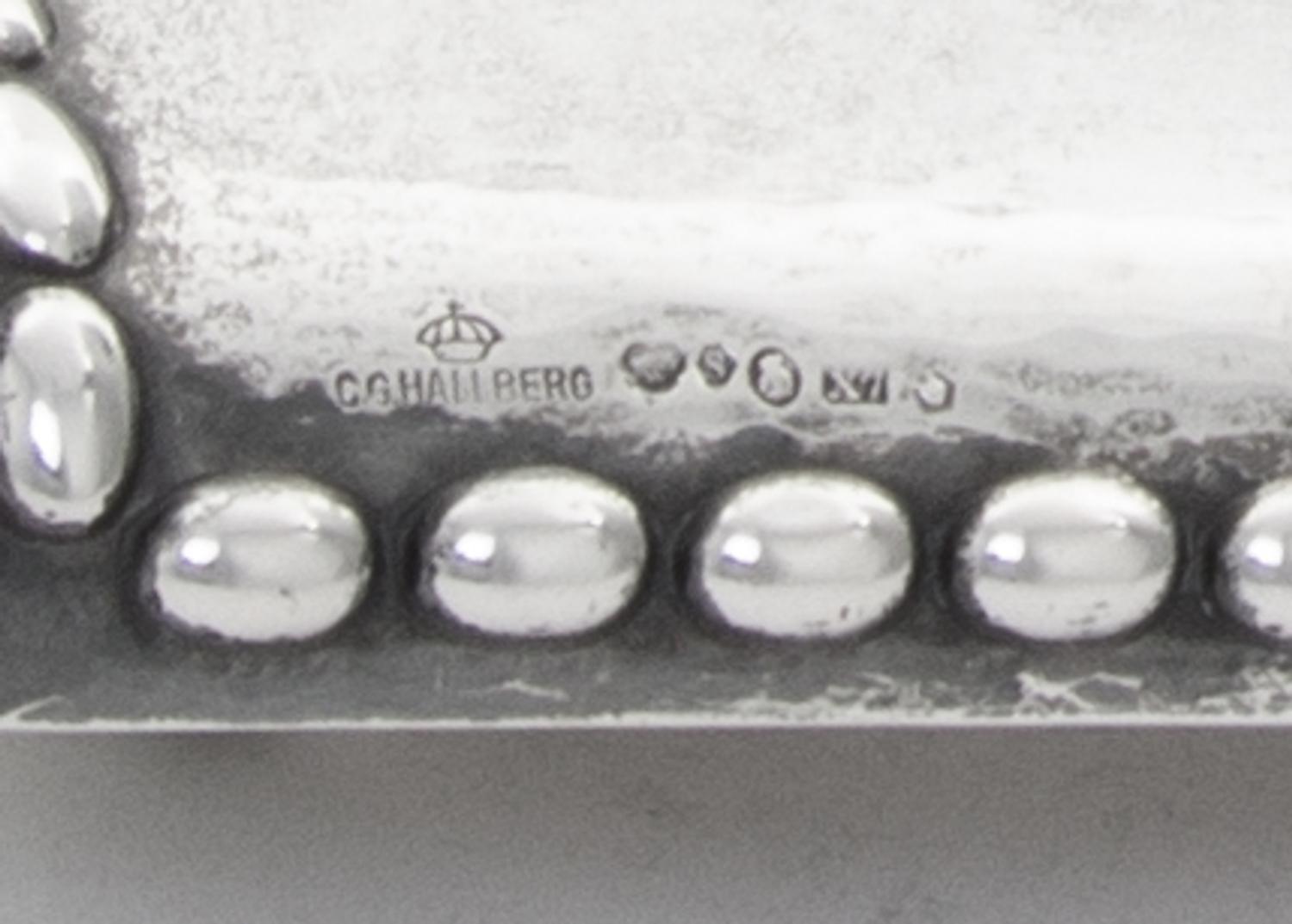 A Swedish Silver Inkstand, G.B. Hallberg, Stockholm, 1924, of rectangular form with a domed backplate, the spot-hammered surface emboss