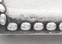 A Swedish Silver Inkstand, G.B. Hallberg, Stockholm, 1924, of rectangular form with a domed backplate, the spot-hammered surface emboss