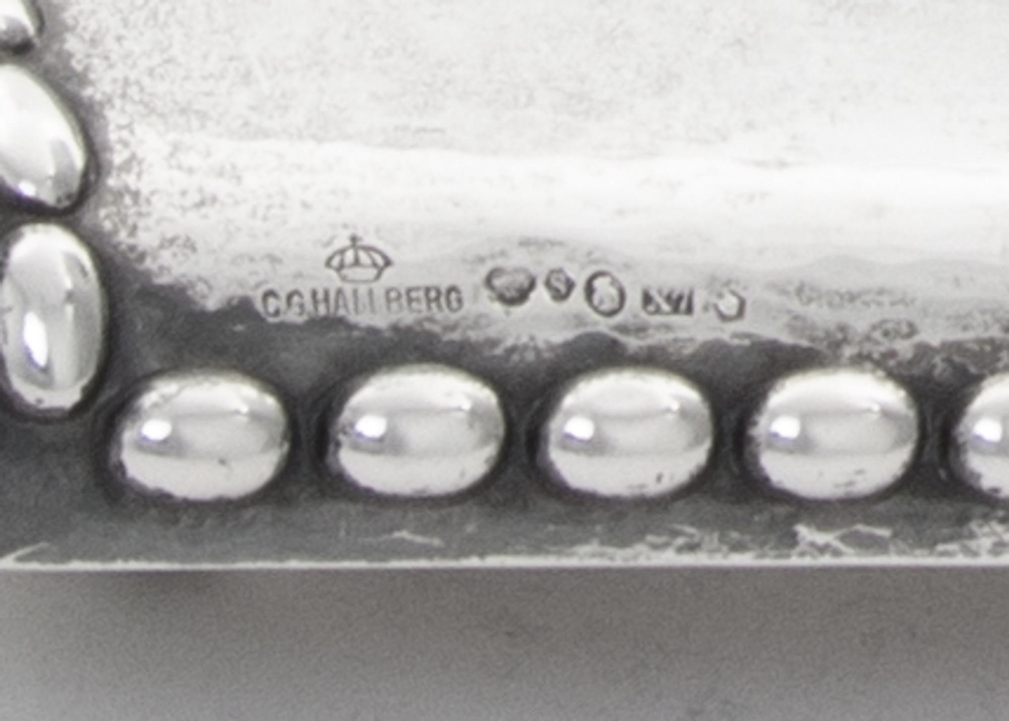 A Swedish Silver Inkstand, G.B. Hallberg, Stockholm, 1924, of rectangular form with a domed backplate, the spot-hammered surface emboss