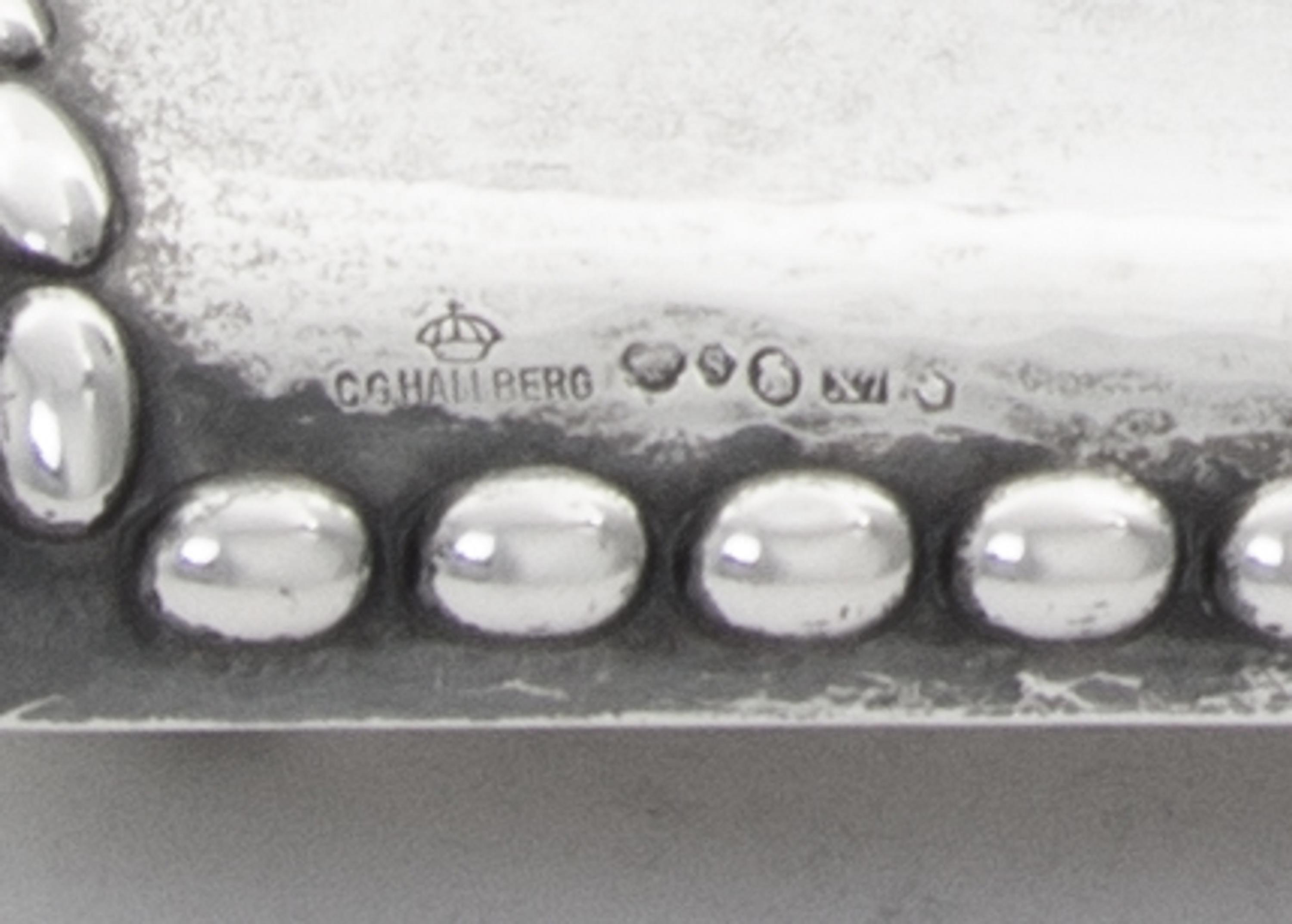 A Swedish Silver Inkstand, G.B. Hallberg, Stockholm, 1924, of rectangular form with a domed backplate, the spot-hammered surface emboss