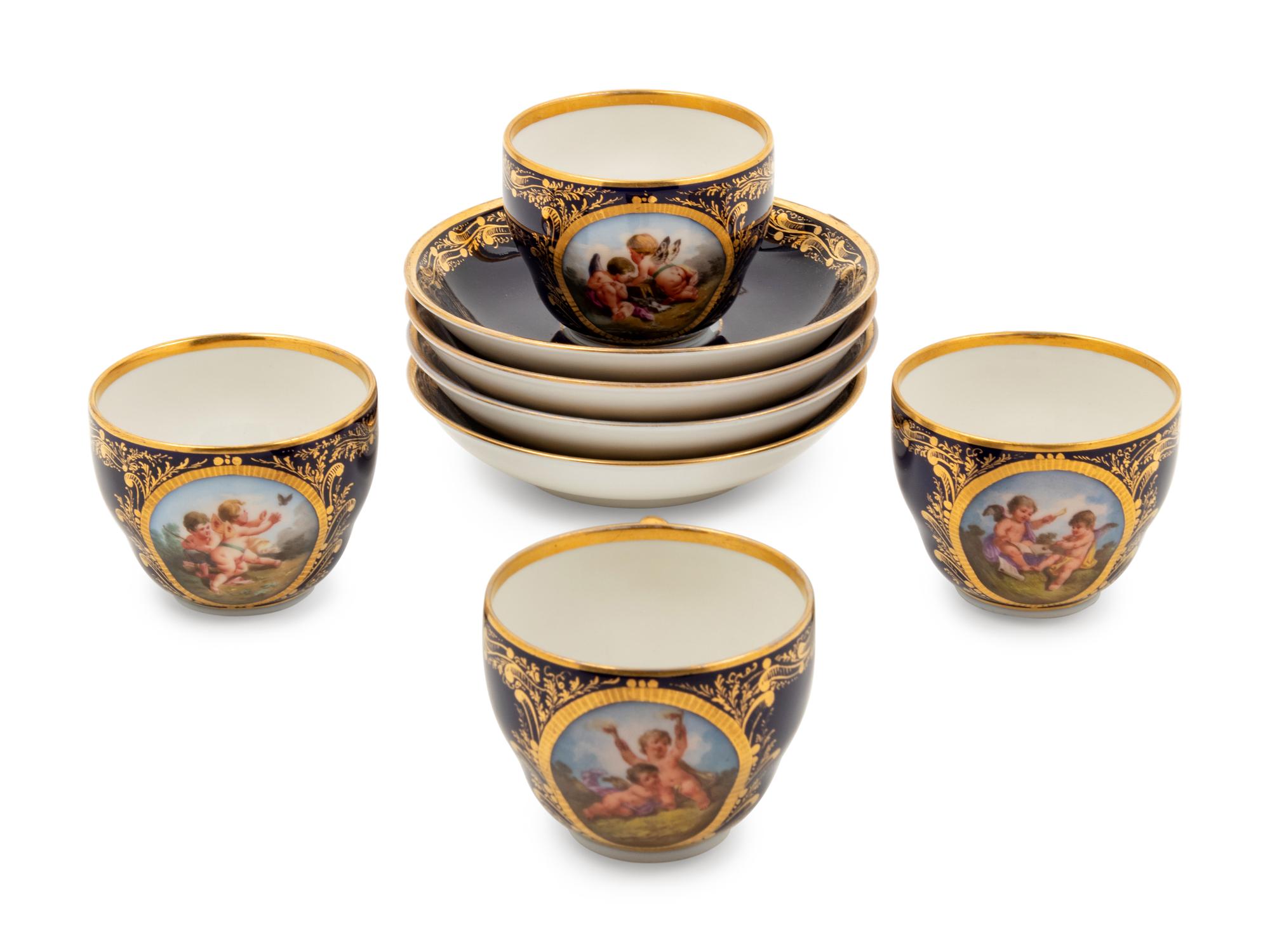 A Set of Four Berlin (K.P.M.) Parcel Gilt Cobalt Ground Porcelain Teacups and Saucers