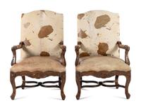 A Pair of Louis XV Style Carved Walnut Fauteuils