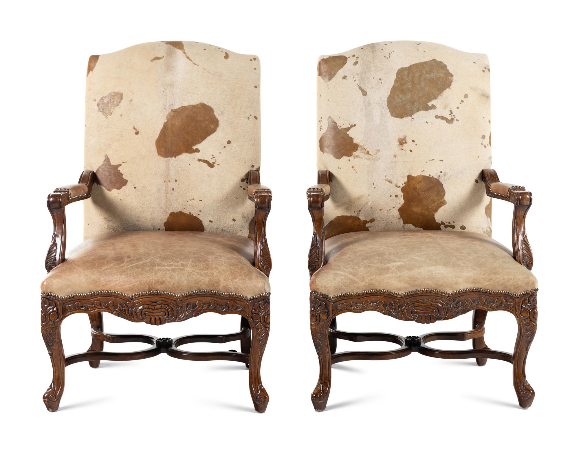 A Pair of Louis XV Style Carved Walnut Fauteuils