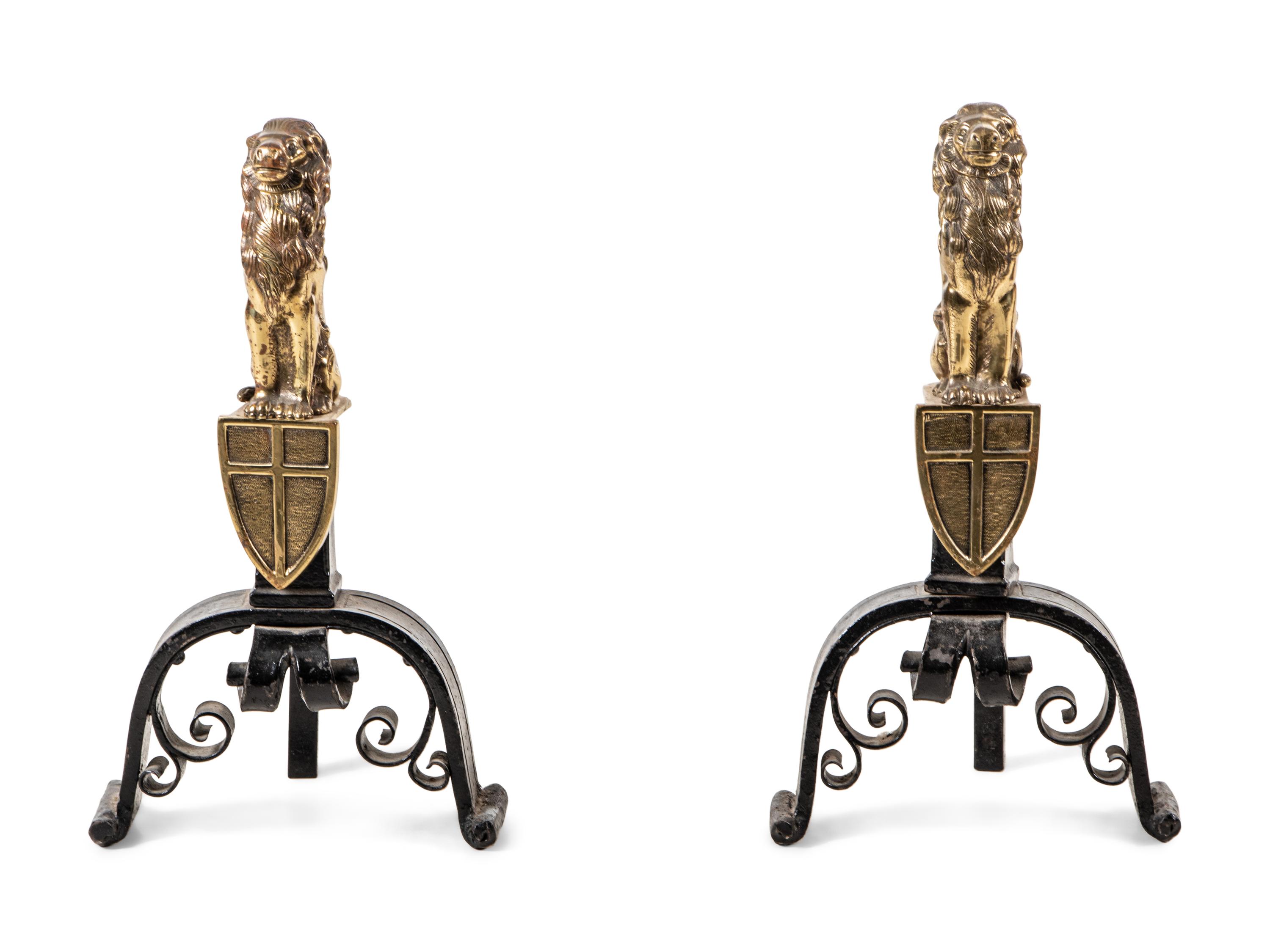 A Pair of English Gilt Brass and Black Painted Iron Andirons with Lion Finials
