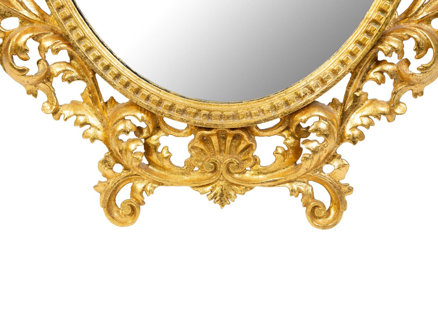 An Italian Rococo Style Carved Giltwood Oval Mirror and a Pair of Wall Brackets