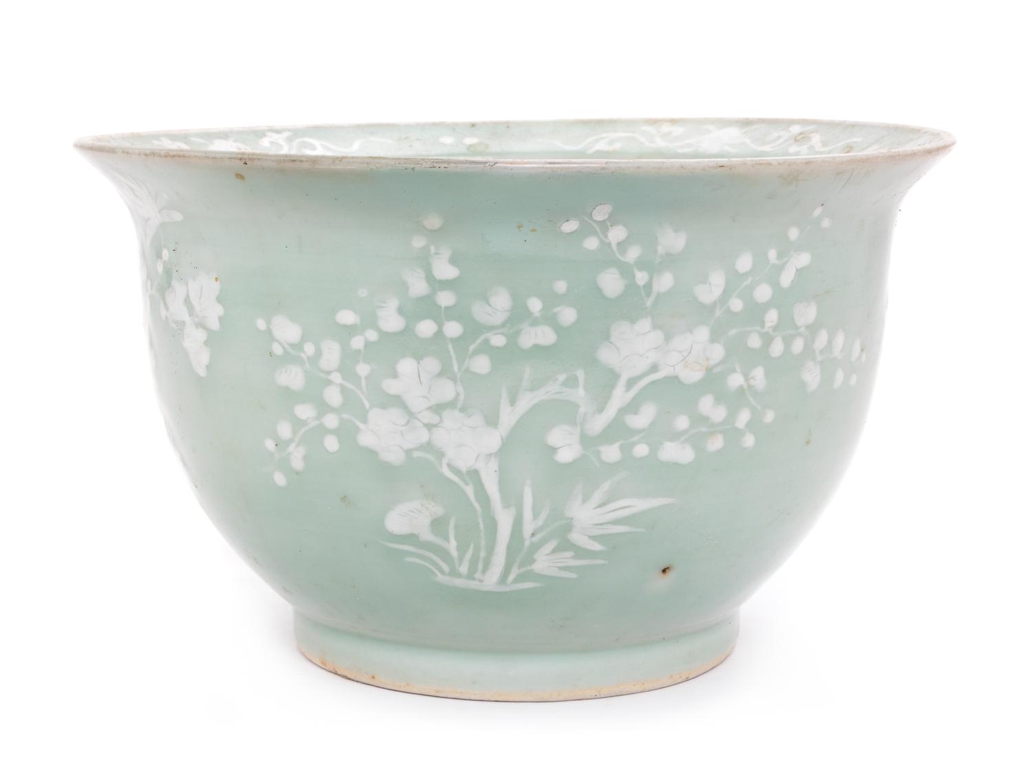 A Chinese White Slip Decorated Celadon Ground Cachepot Diameter 11 1/8 inches.