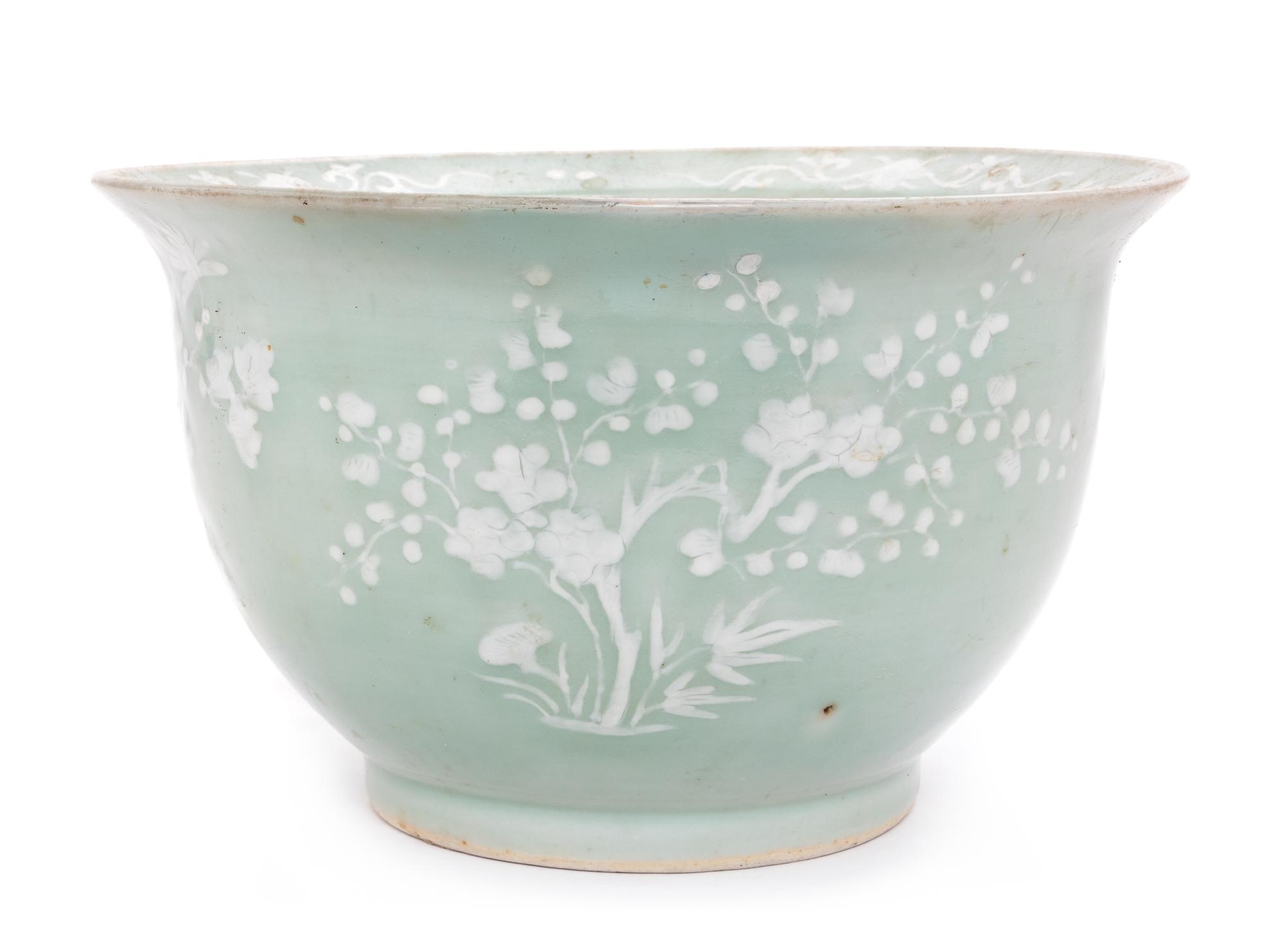 A Chinese White Slip Decorated Celadon Ground Cachepot Diameter 11 1/8 inches.
