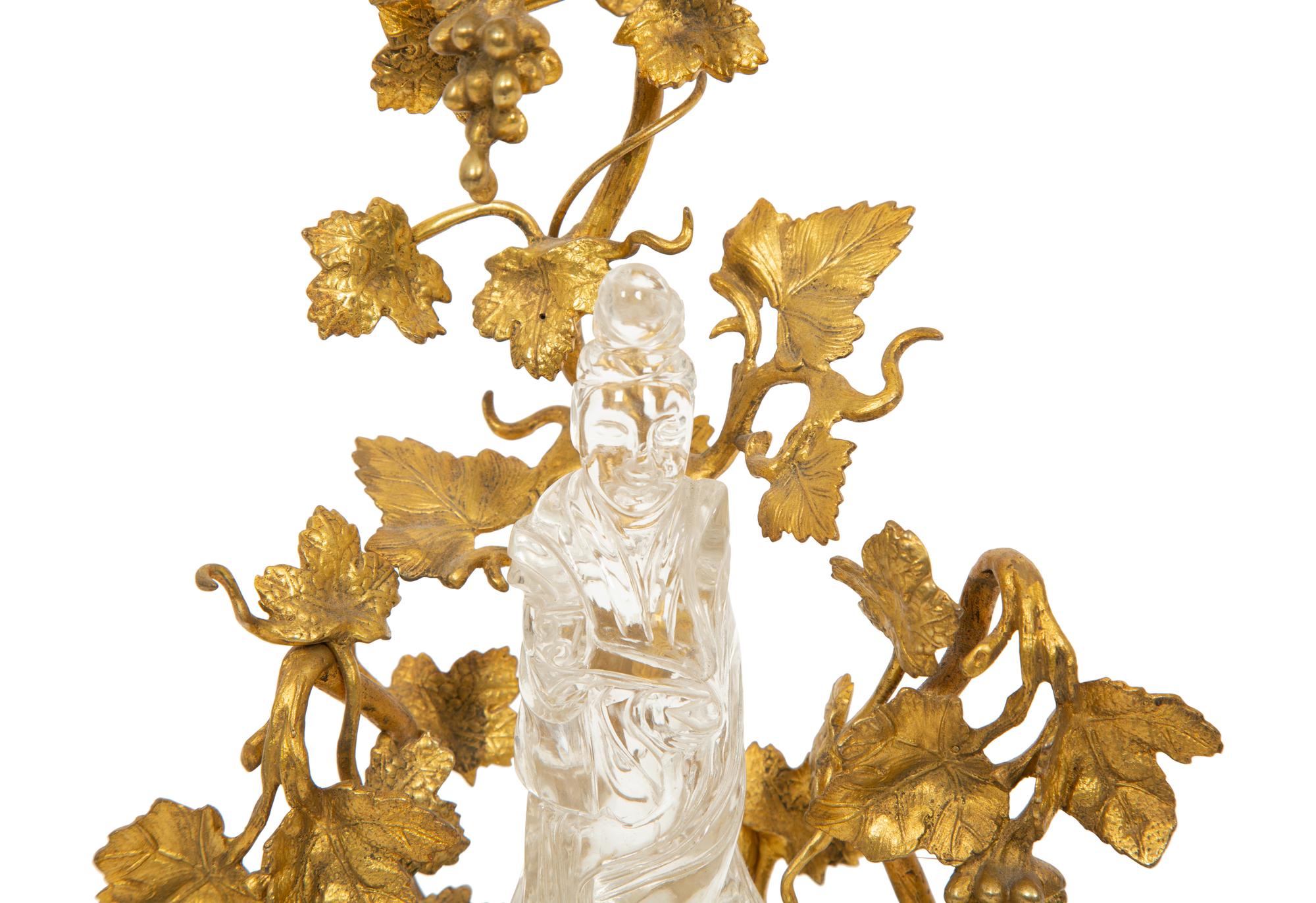 A Carved Rock Crystal Figure of Guanyin on a Grapevine Decorated Gilt Bronze Stand