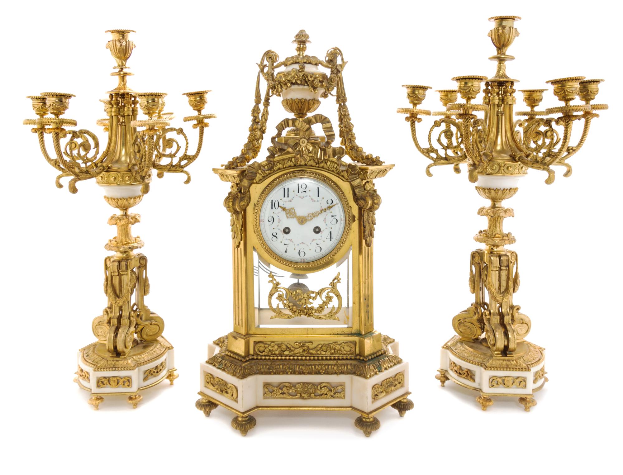 A Louis XVI Style Gilt Bronze and Marble Clock Garniture Height of candelabra 22 3/4 inches. — MOVEMENT BY A.D. MOUGIN, PARIS, LATE 19TH CENTURY