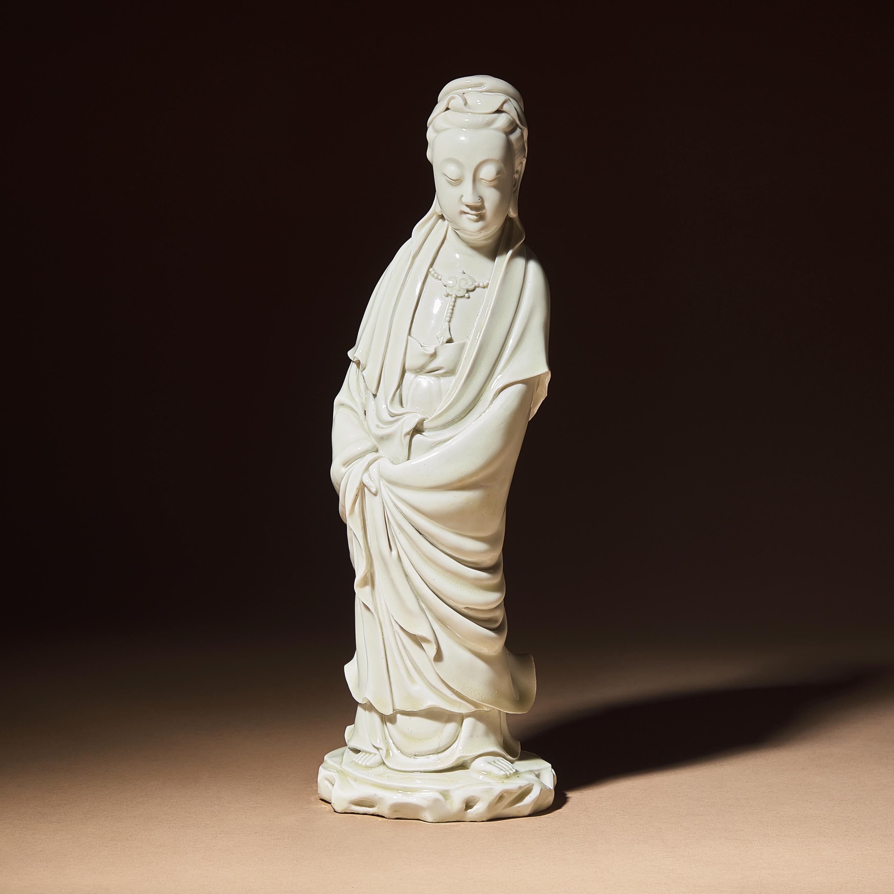 A Chinese Blanc-de-Chine Porcelain Standing Figure of Guanyin with 'He Chaozong' Mark, Qing Dynasty — 清 何朝宗款德化白瓷觀音立像