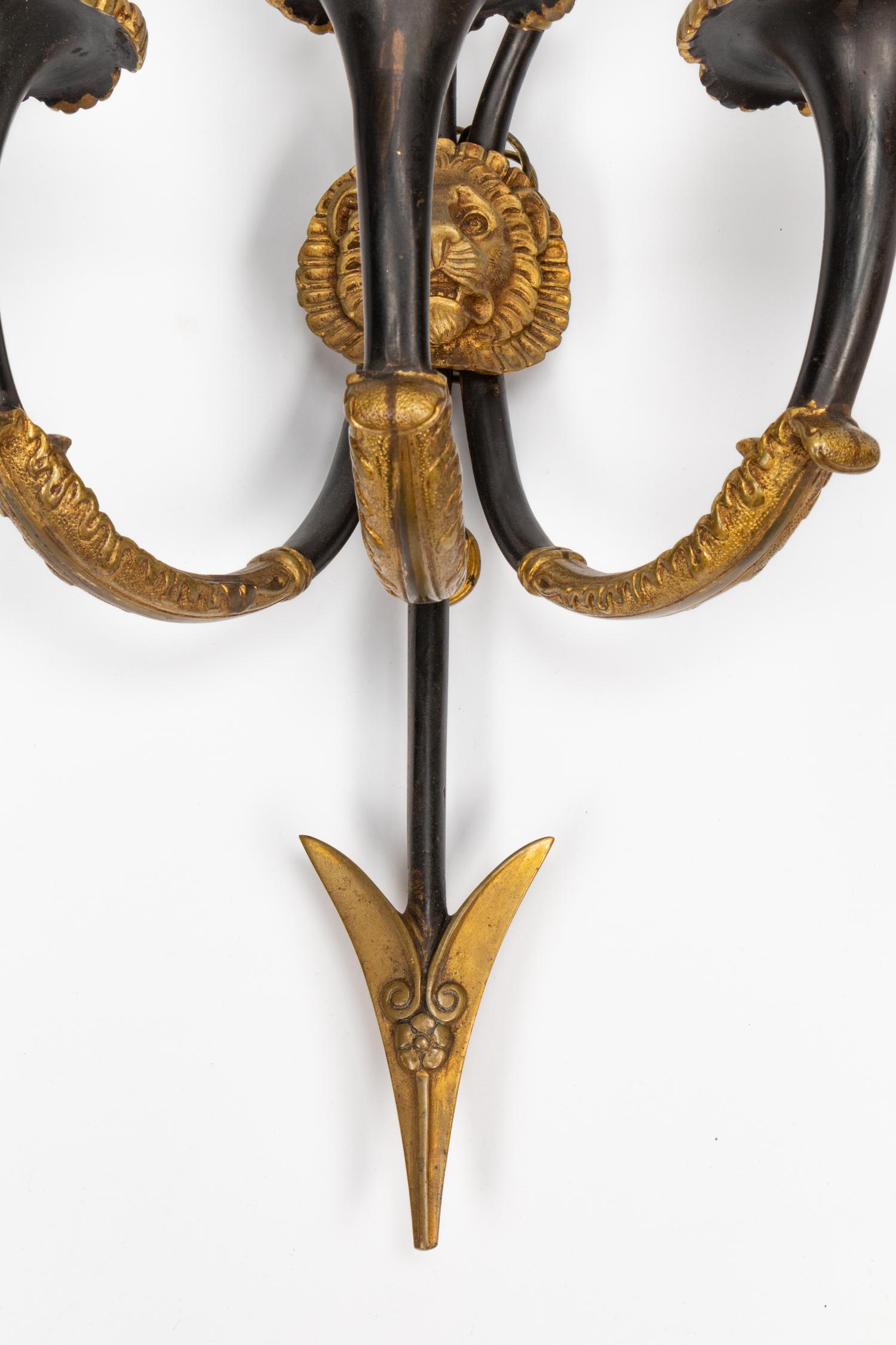 A Pair of Empire Style Gilt and Patinated Bronze Three-Light Sconces