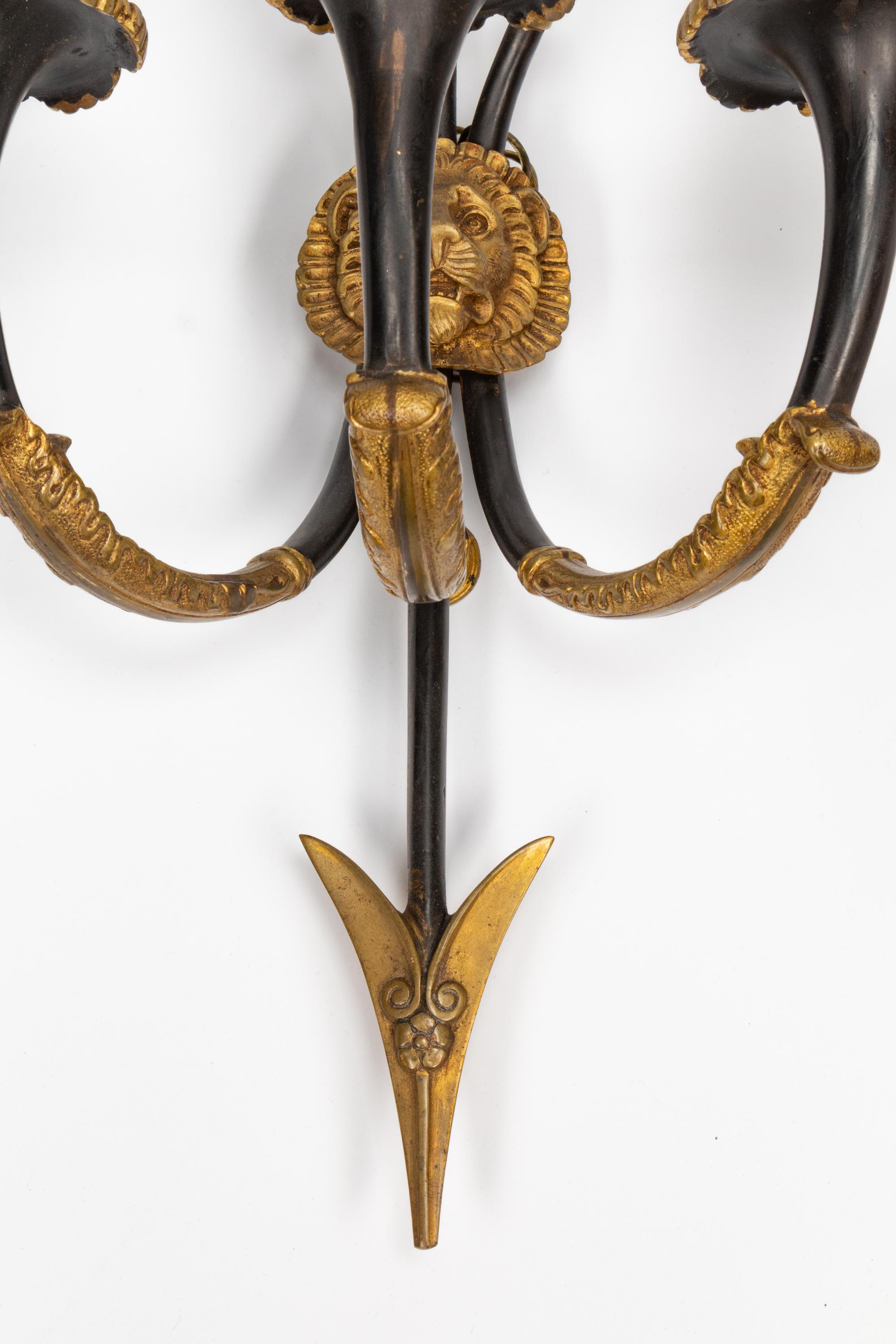 A Pair of Empire Style Gilt and Patinated Bronze Three-Light Sconces