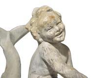 A lead or zinc fountain head in the form of a putto riding a dolphin, 19th / 20th century