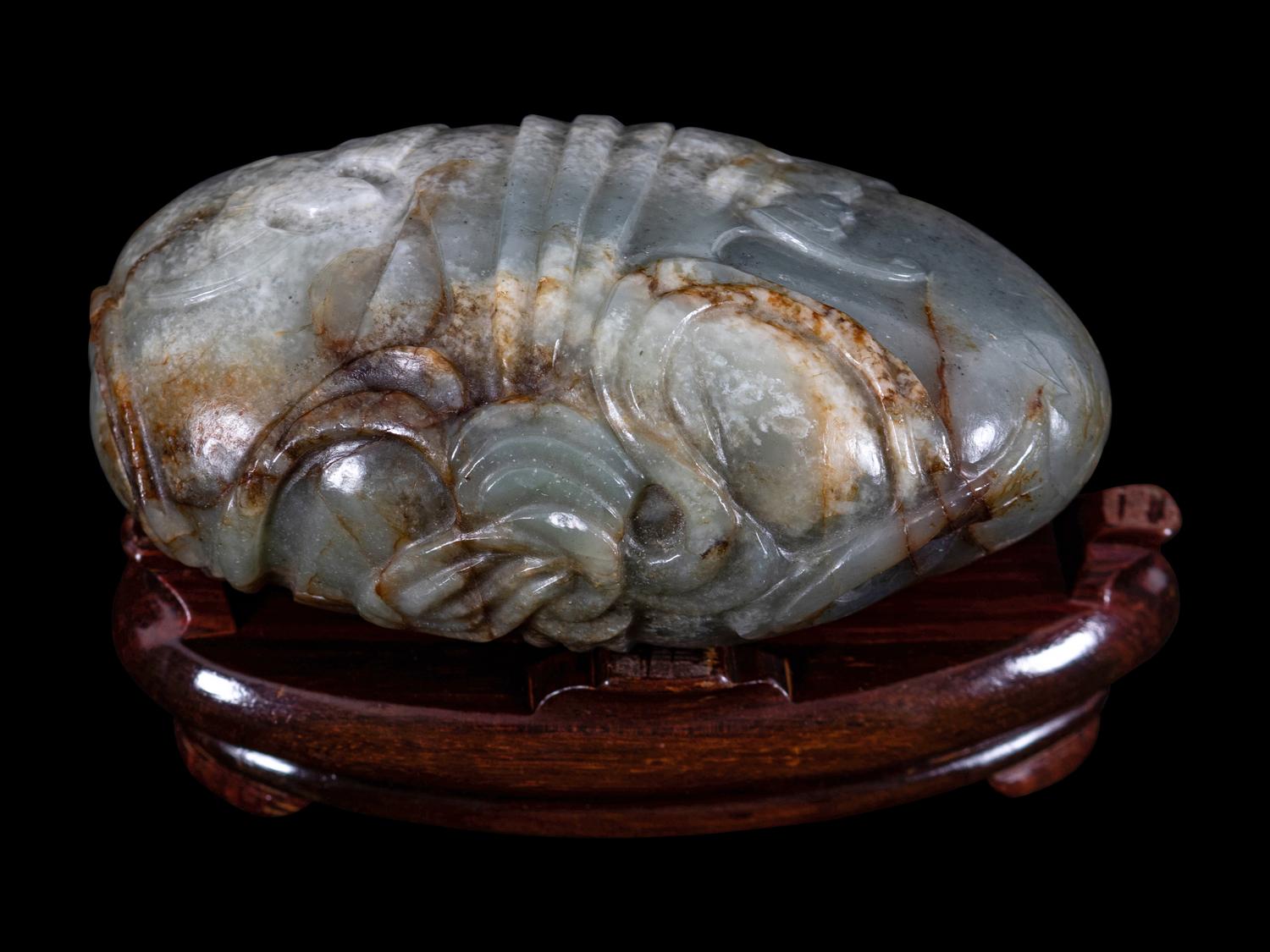 A Grey and Russet Jade Purse-Form Paperweight