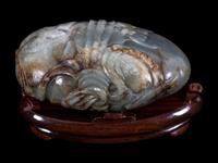 A Grey and Russet Jade Purse-Form Paperweight