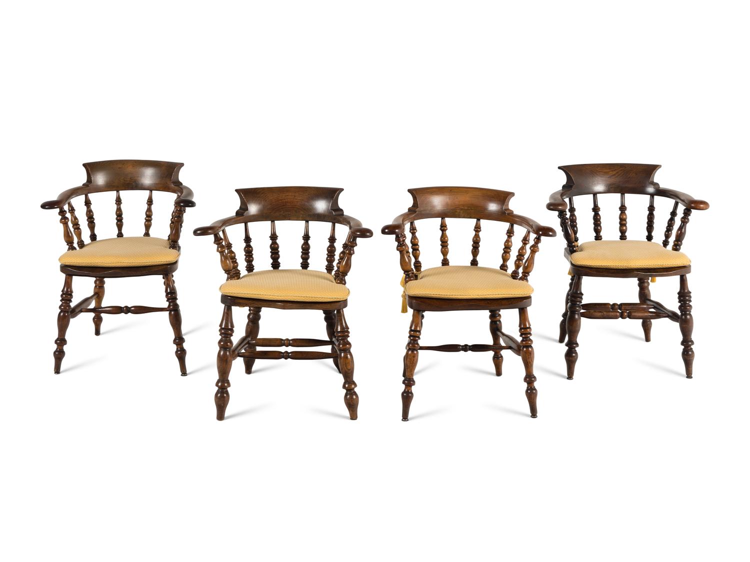A Group of Four Oak Captain's Armchairs
