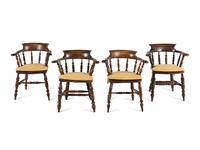 A Group of Four Oak Captain's Armchairs