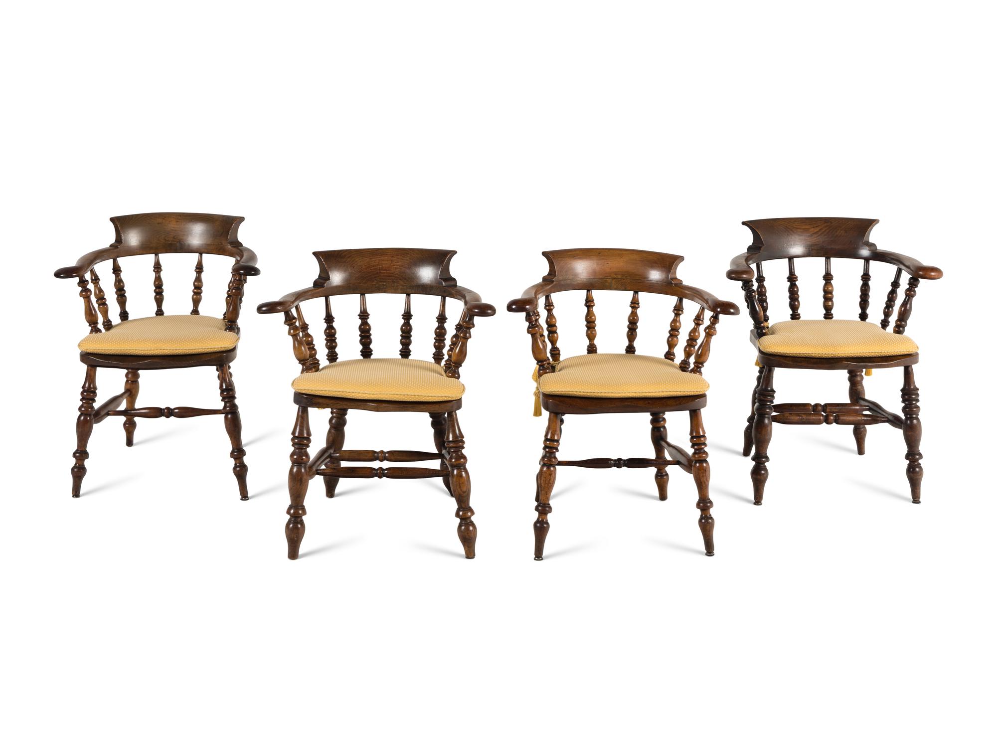A Group of Four Oak Captain's Armchairs