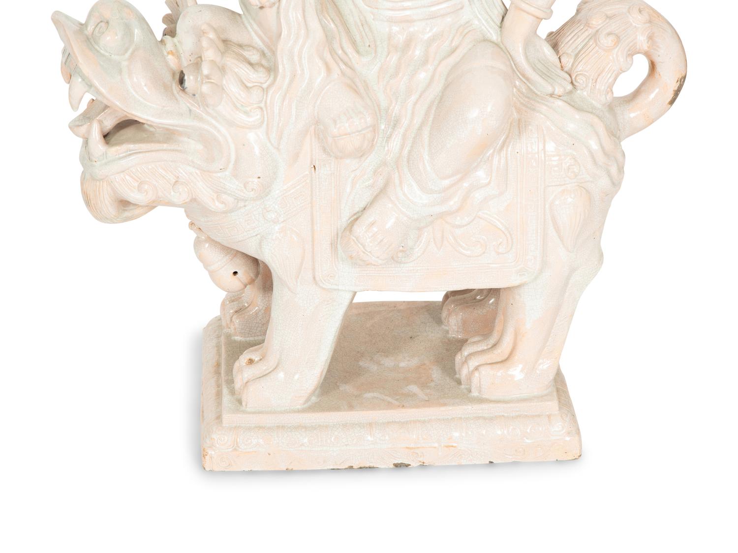 A Pair of Chinese Glazed Ceramic Figures of Guan Yin Atop a Foo Dog