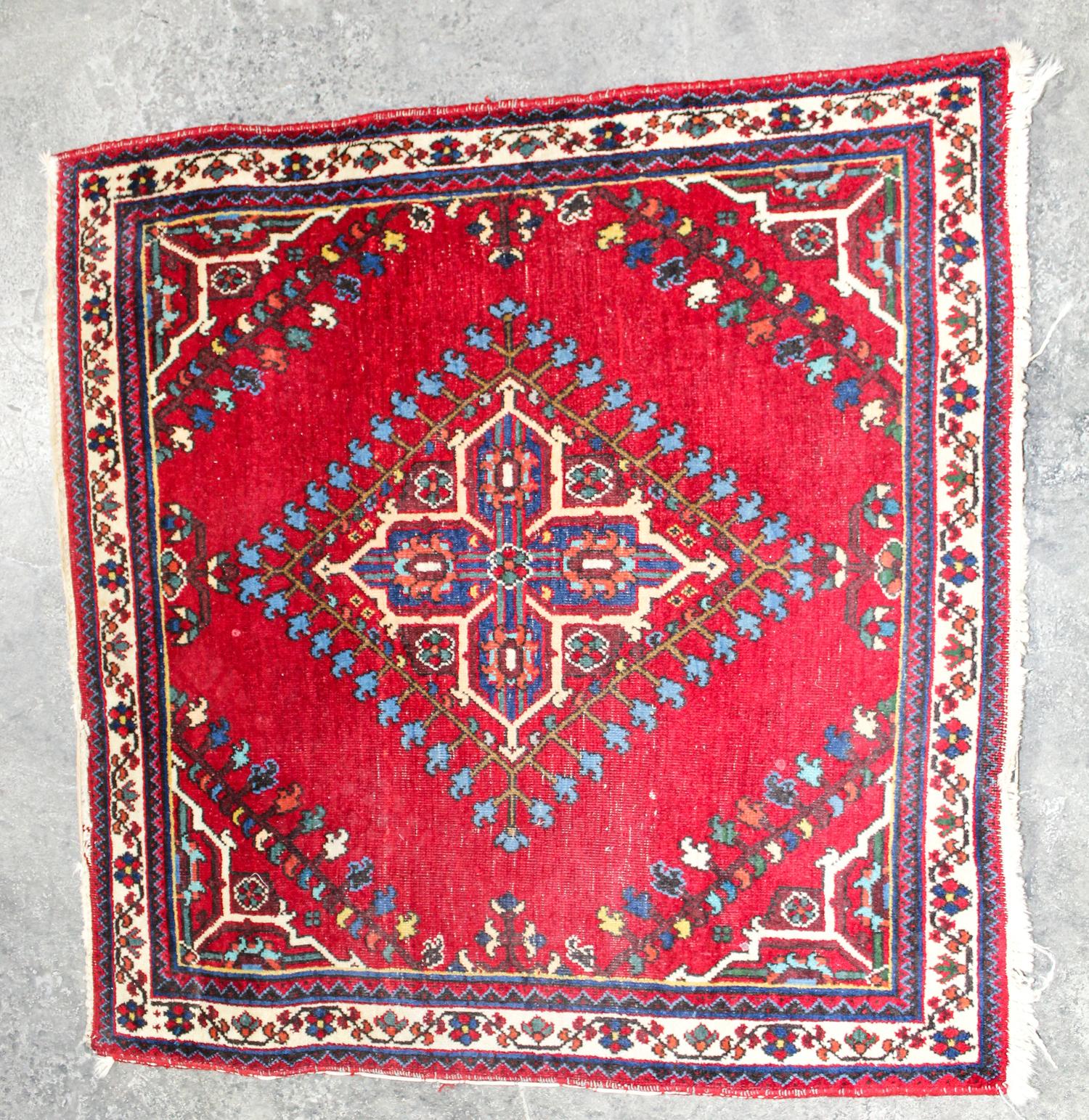 A Persian Mat 2 feet 9 inches x 2 feet 8 inches.